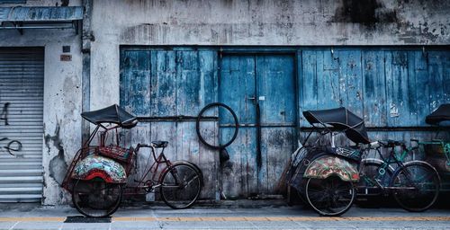 Bicycles parked against wall in old building