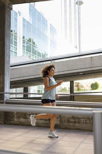 Young athlete running exercising while running on bridge