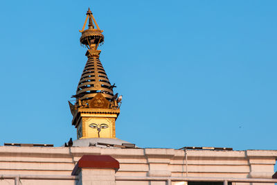 Low angle view of traditional building against clear blue sky