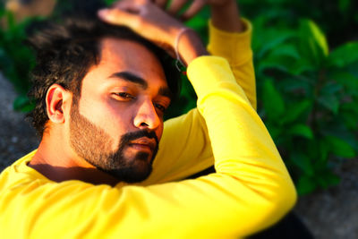 Portrait of young man looking away outdoors