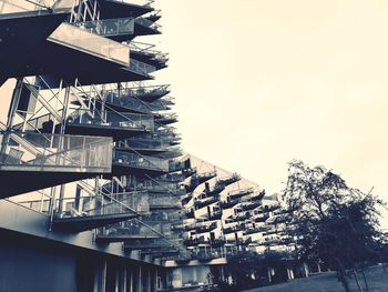 Low angle view of bridge and buildings against sky