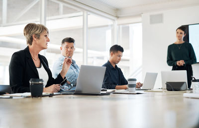 A businesswoman having a meeting in the boardroom with her team. a female leader at a presentation