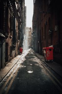 Narrow street amidst buildings in city