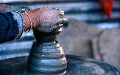 Cropped hands of potter working at workshop