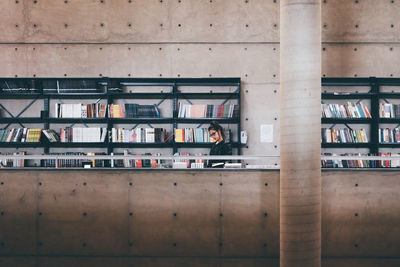 Portrait of man reading book in library