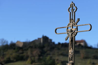 Low angle view of cross against clear blue sky