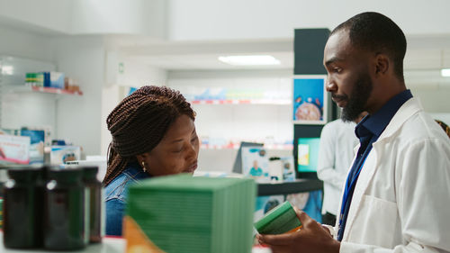 Side view of young man working in office