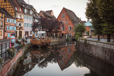 Canal by houses in city