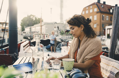 Female entrepreneur using laptop while working remotely in houseboat