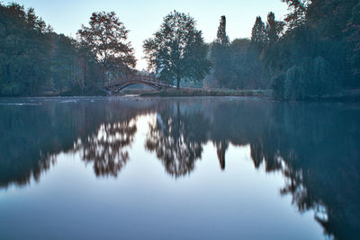 Reflection of trees in lake against sky