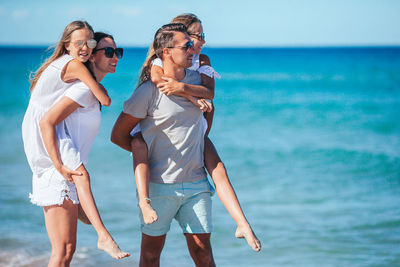 Friends standing at beach