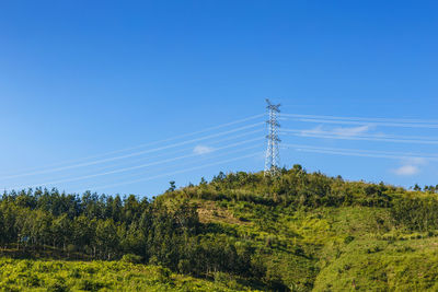 Low angle view of electricity pylon against sky