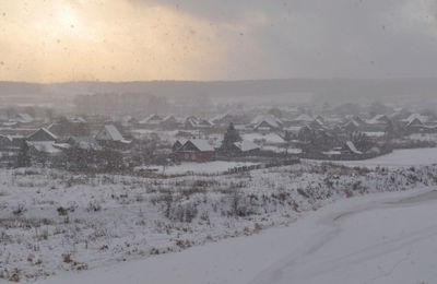 Scenic view of snow covered landscape against sky