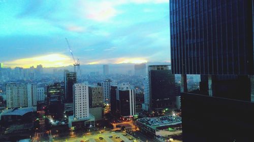 Skyscrapers in city at dusk