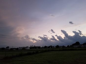 Scenic view of field against sky at sunset