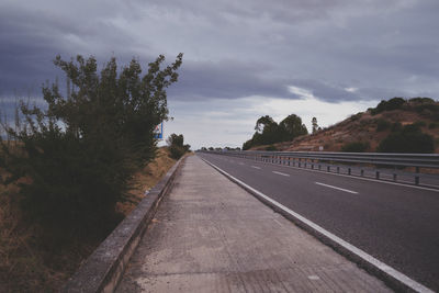 View of road against cloudy sky