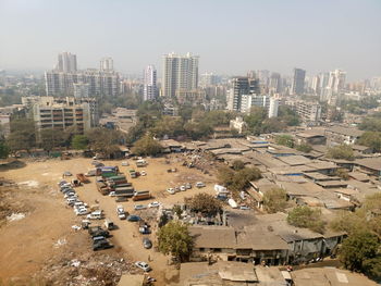 High angle view of slums in city against sky