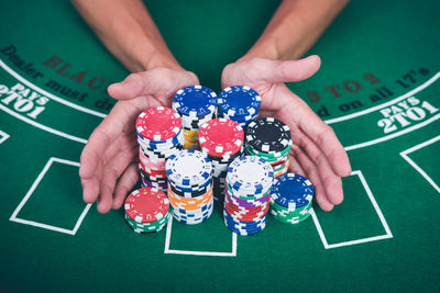 Cropped image of man with gambling chips at casino