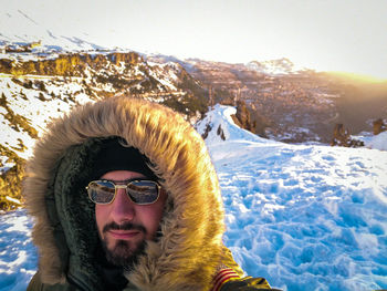 Portrait of smiling young man in warm clothes