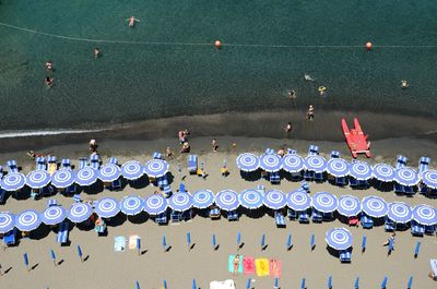 Aerial view of parasols and lounge chairs at beach