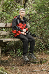 Full length of a young man looking away in forest