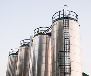 Low angle view of storage tank against sky