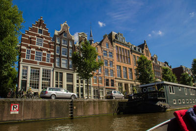 Cars in city against sky