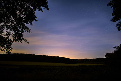 Scenic view of landscape against sky at dusk