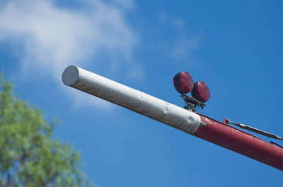 Low angle view of telephone pole against blue sky