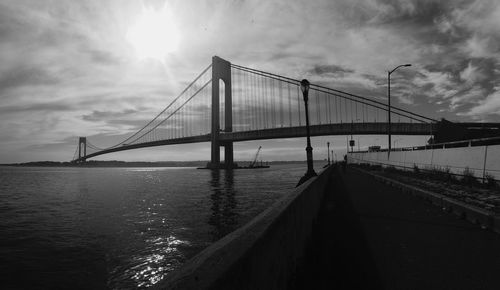 View of bridge over river against cloudy sky