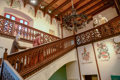 Low angle view of people standing on staircase