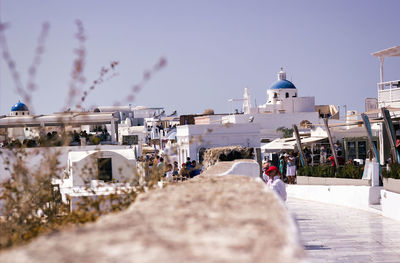 Buildings in city against clear sky