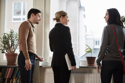 Real estate agent talking to couple in new house