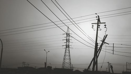 Low angle view of electricity pylon against sky