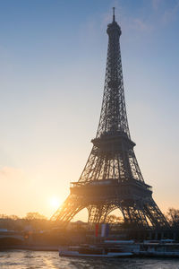 Low angle view of tower against sky during sunset