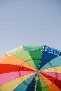 Low angle view of umbrella against clear sky