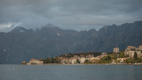 Scenic view of sea and mountains against sky