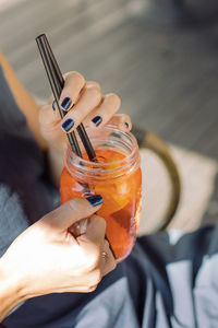 Midsection of woman holding drink