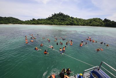 High angle view of people swimming in lake