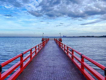 Pier over sea against sky