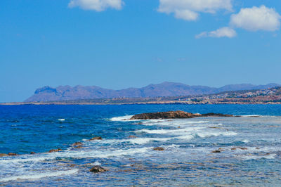 Scenic view of sea against blue sky