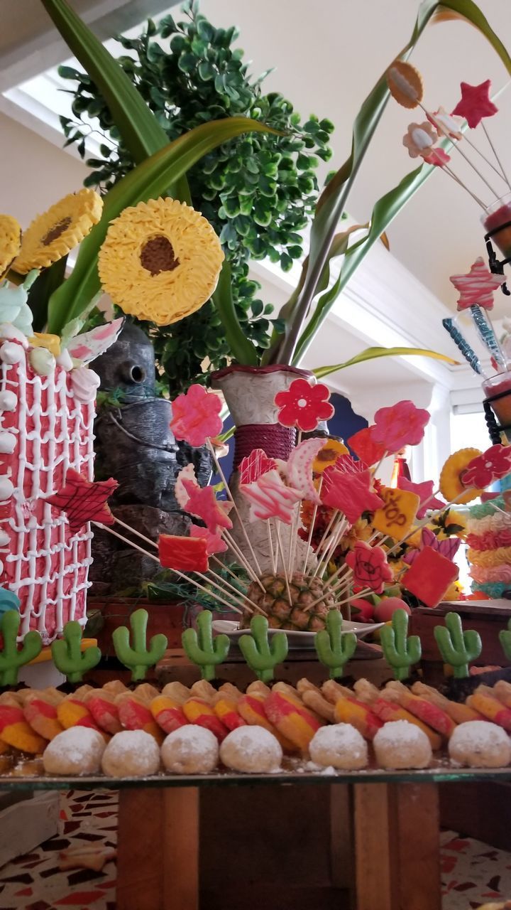 CLOSE-UP OF MULTI COLORED FLOWERS ON WALL