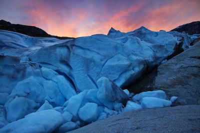 Scenic view of snow mountains against sky during sunset