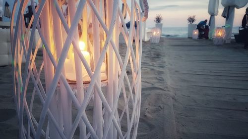 Close-up of illuminated lighting equipment on beach