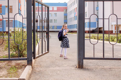 Back to school. girl in school uniform go to school with backpack behind their backs. beginning 