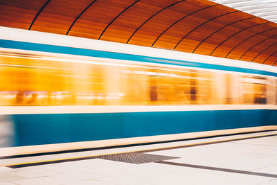 Blurred motion of train at railroad station