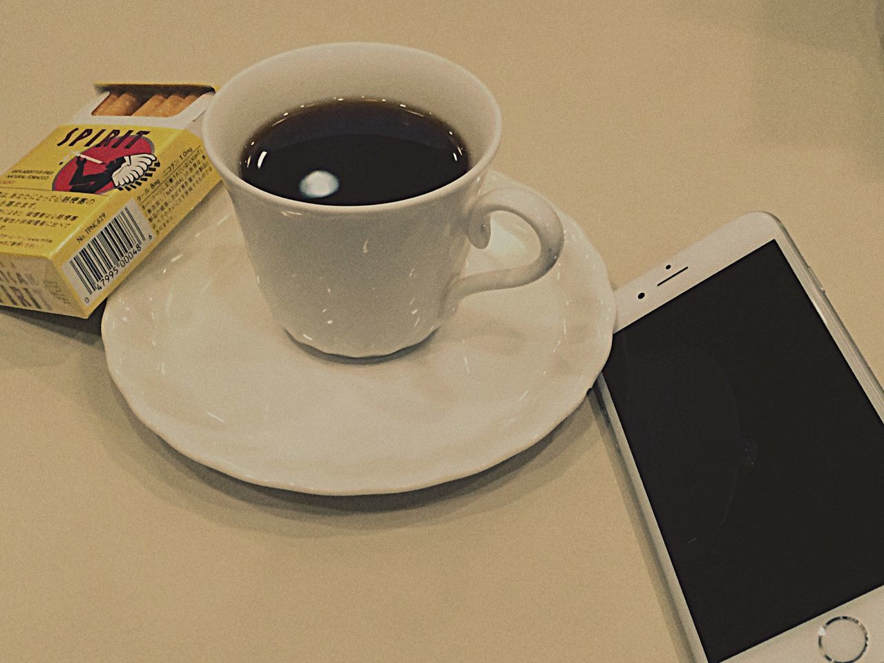 indoors, coffee cup, table, still life, drink, food and drink, coffee - drink, high angle view, refreshment, close-up, cup, coffee, communication, no people, technology, saucer, plate, paper, spoon, freshness