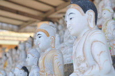Close-up of buddha statue against building