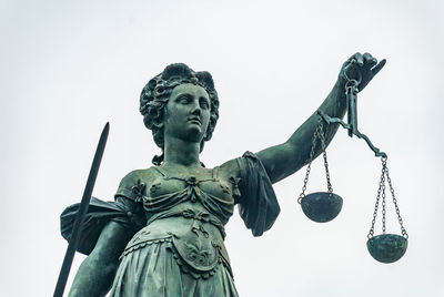 Low angle view of statue against sky