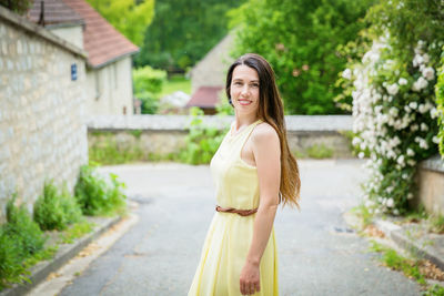 Lifestyle portrait of young stylish woman with long brunette hair